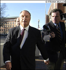 MOVING TARGET: Urciuoli (center) takes part in the Rhode Island ritual of another scandal-related arraignment.